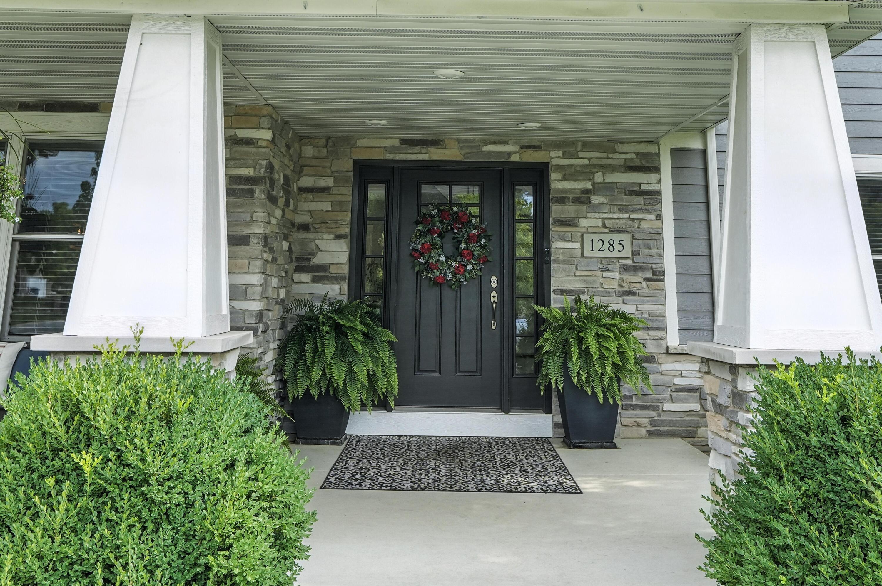 1285 Greenview Place Crown Point, IN 46307 - Photo 4 of 51 a front view of a house with potted plants