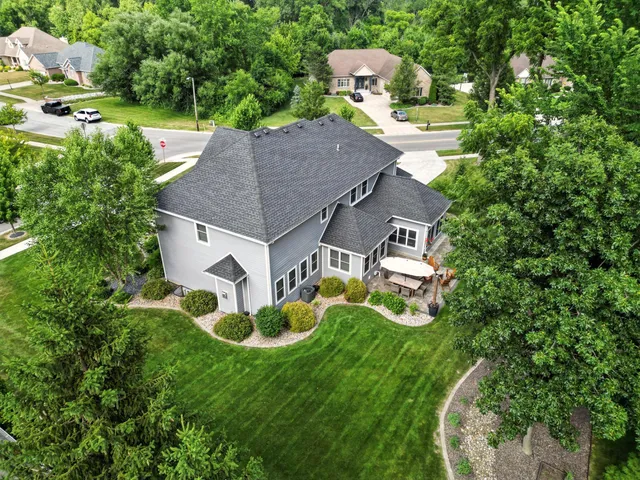 an aerial view of a house with garden space and street view