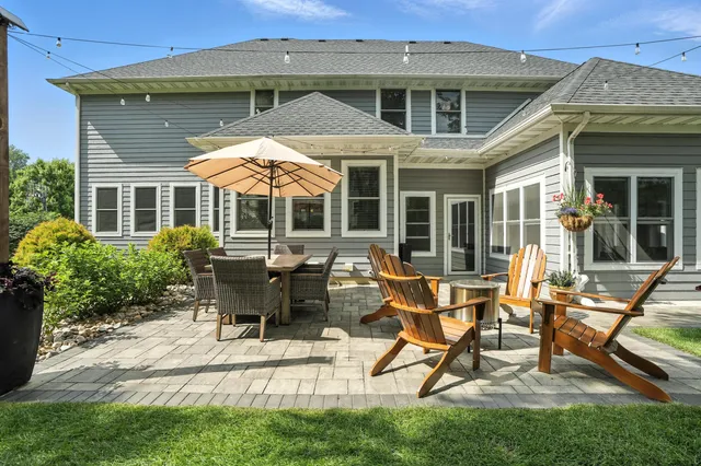 a view of a house with backyard sitting area and garden