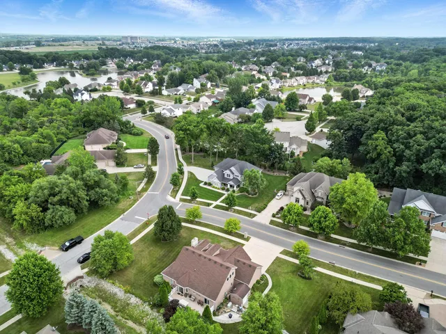 an aerial view of a house with a garden and trees