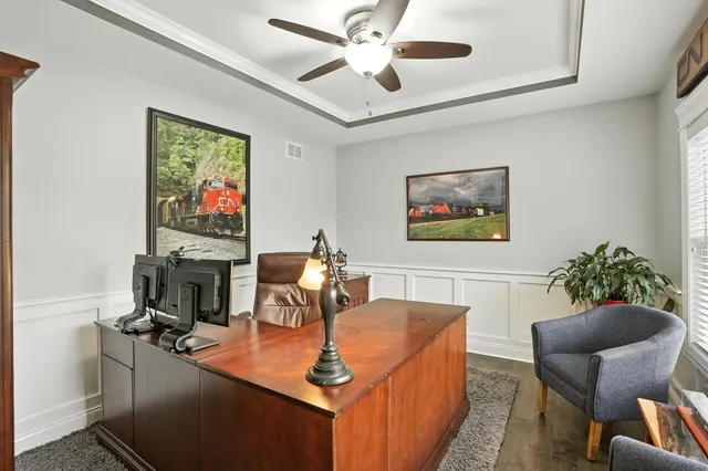 a dining room with furniture and a flat screen tv