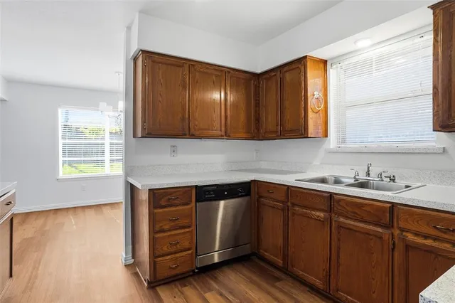 a kitchen with sink cabinets and wooden floor