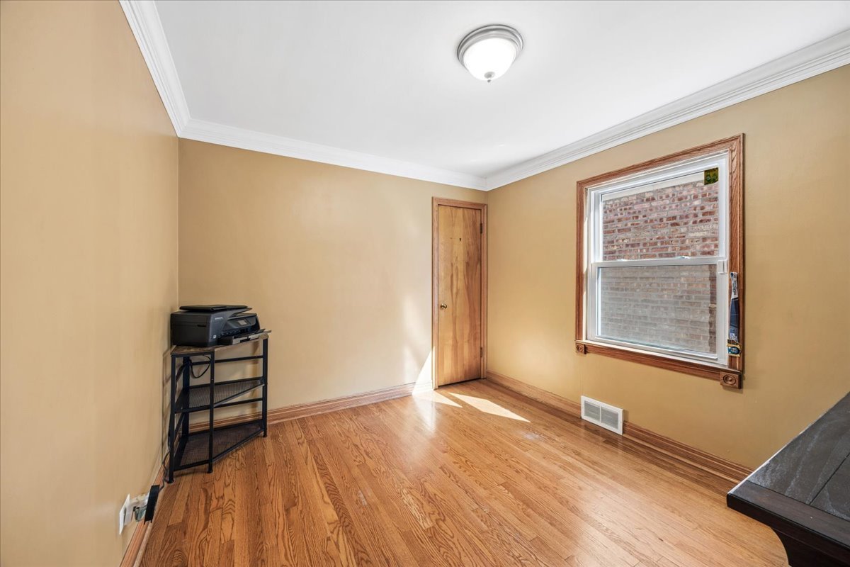 6140 South Kostner Avenue Chicago, IL 60629 - Photo 11 of 24 an empty room with wooden floor and windows