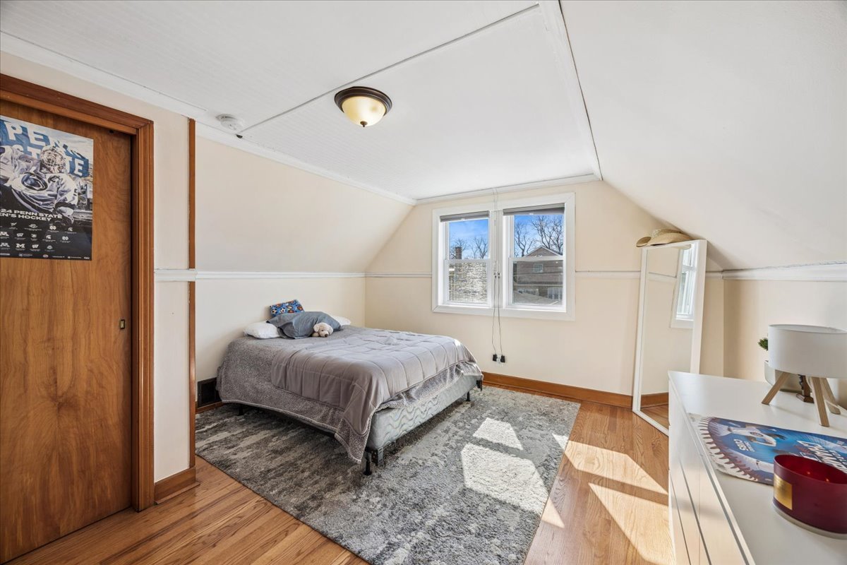 6140 South Kostner Avenue Chicago, IL 60629 - Photo 15 of 24 a bedroom with a bed and wooden floor