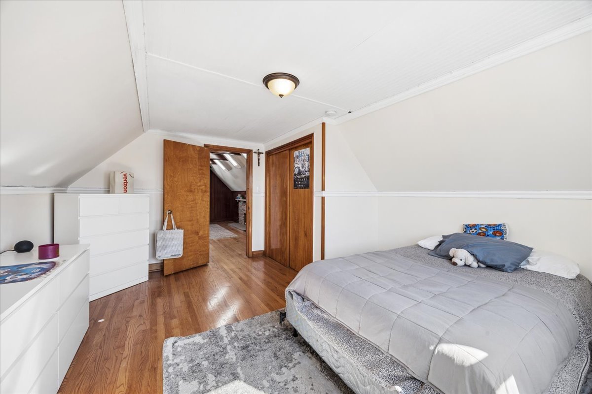 6140 South Kostner Avenue Chicago, IL 60629 - Photo 16 of 24 a bedroom with a bed and wooden floor