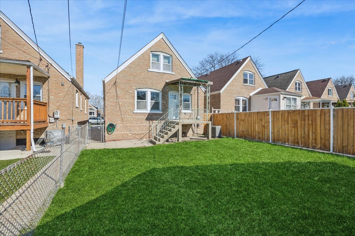6140 South Kostner Avenue Chicago, IL 60629 - Photo 20 of 24 a front view of a house with a yard