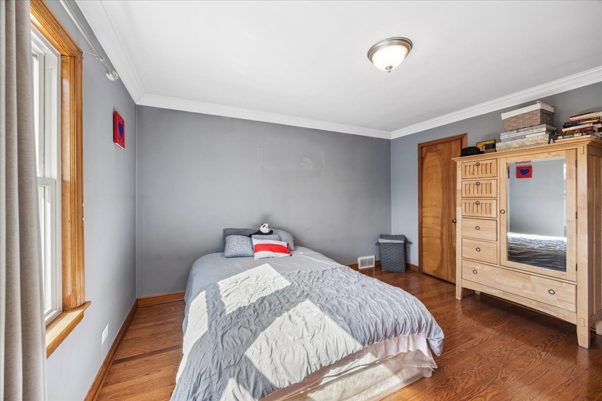6140 South Kostner Avenue Chicago, IL 60629 - Photo 10 of 24 a bedroom with a bed and a dresser