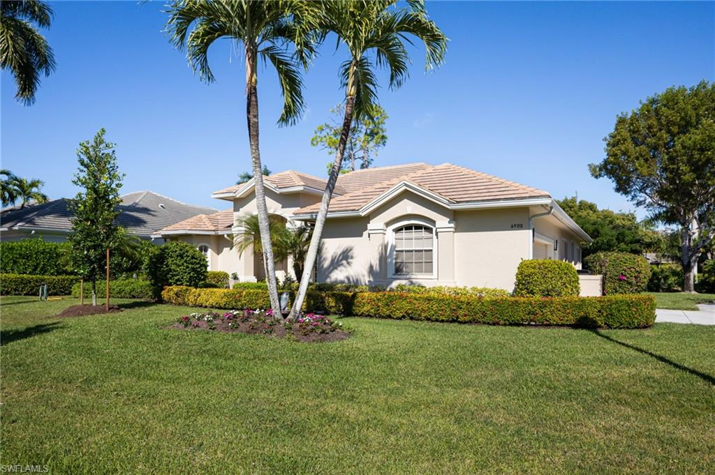 6900 Mill Run Road Naples, FL 34109 - Photo 11 of 31 a front view of a house with garden