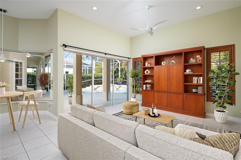 6900 Mill Run Road Naples, FL 34109 - Photo 18 of 31 a living room with furniture and a floor to ceiling window