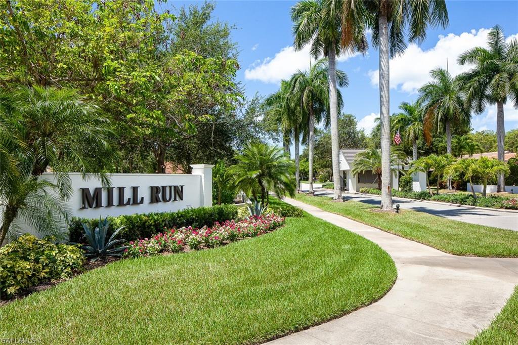 6900 Mill Run Road Naples, FL 34109 - Photo 25 of 31 a view of a house with a yard and palm trees