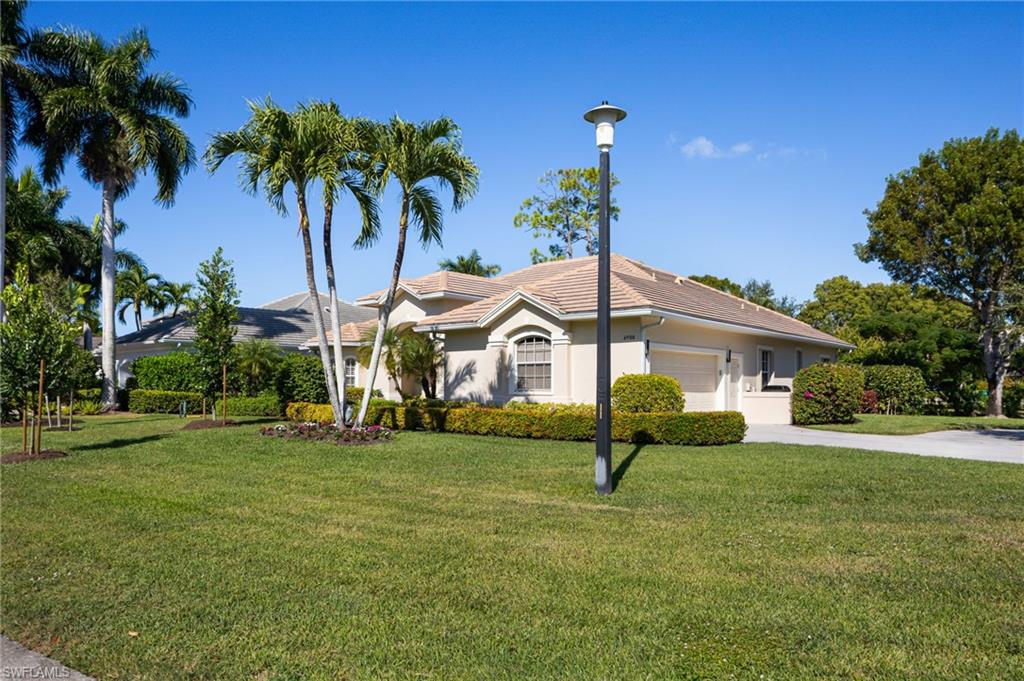 6900 Mill Run Road Naples, FL 34109 - Photo 10 of 31 a house with garden in front of it