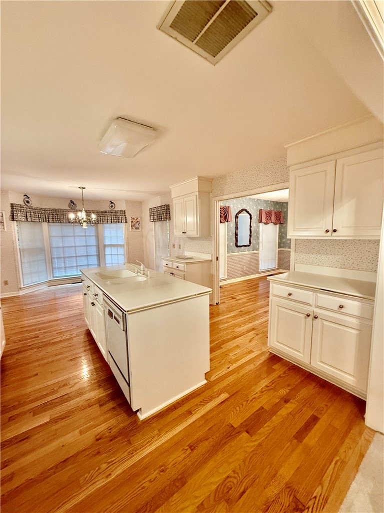 235 Stonehaven Way Seneca, SC 29672 - Photo 19 of 35 A flowing layout connects kitchen functionality with an adjacent living area, all grounded by rich hardwood floors.