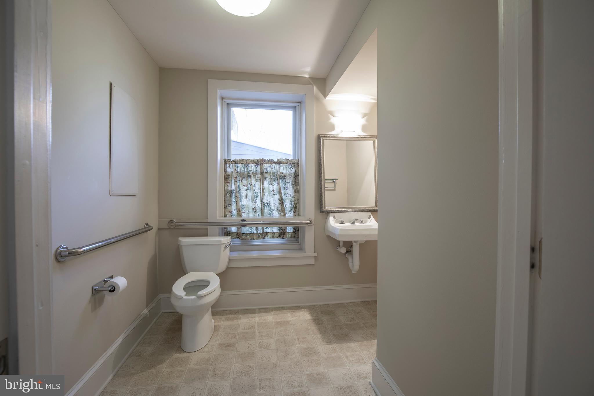 169 North Main Street Doylestown, PA 18901 - Photo 26 of 53 a bathroom with a granite countertop sink a toilet and a window
