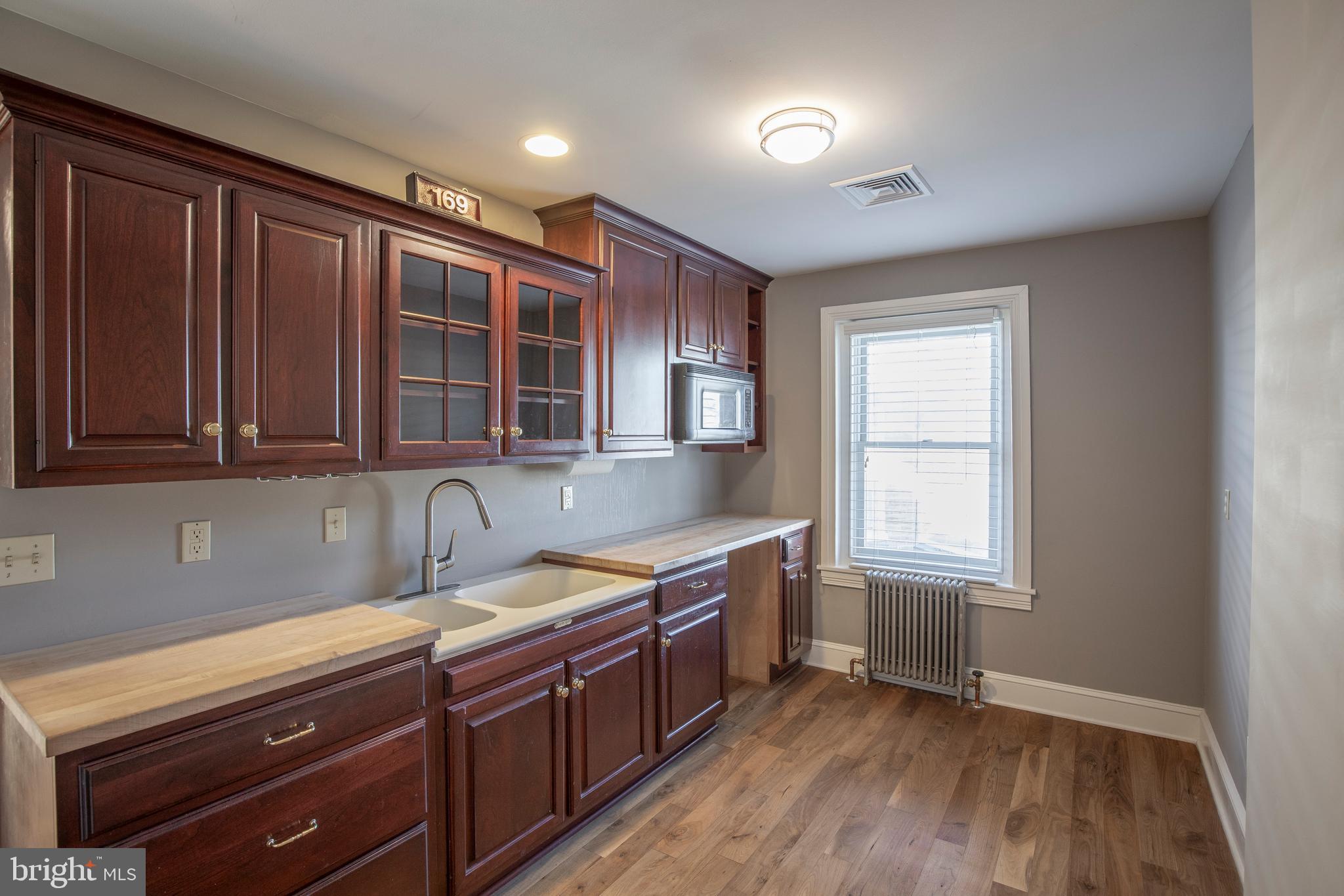 169 North Main Street Doylestown, PA 18901 - Photo 47 of 53 a kitchen with stainless steel appliances granite countertop wooden cabinets a sink and dishwasher with wooden floor