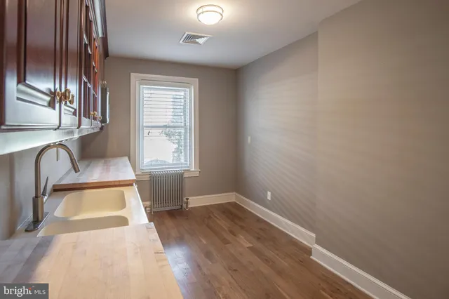 an empty room with wooden floor and closet