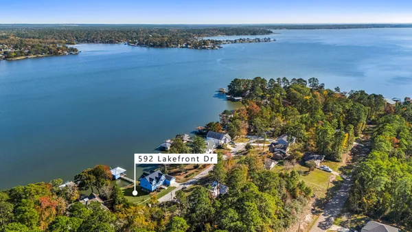 an aerial view of a houses with a lake view