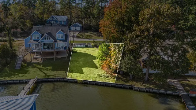 an aerial view of a house with pool lake and mountain view