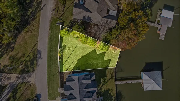 a view of a lake with a bench and bench in the back yard