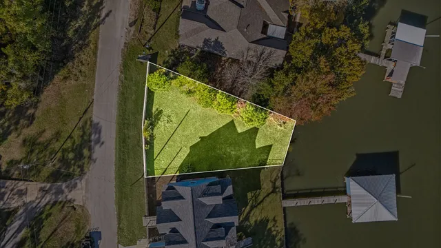 a view of a lake with a bench and bench in the back yard