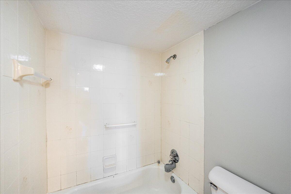 950 South Kanner Highway, Unit E4 Stuart, FL 34994 - Photo 18 of 33 a bathroom with a toilet and a shower