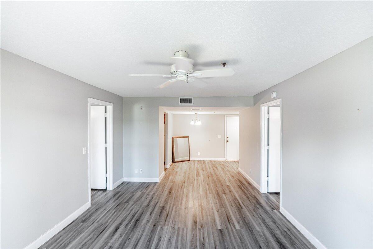 950 South Kanner Highway, Unit E4 Stuart, FL 34994 - Photo 21 of 33 wooden floor in an empty room with a window