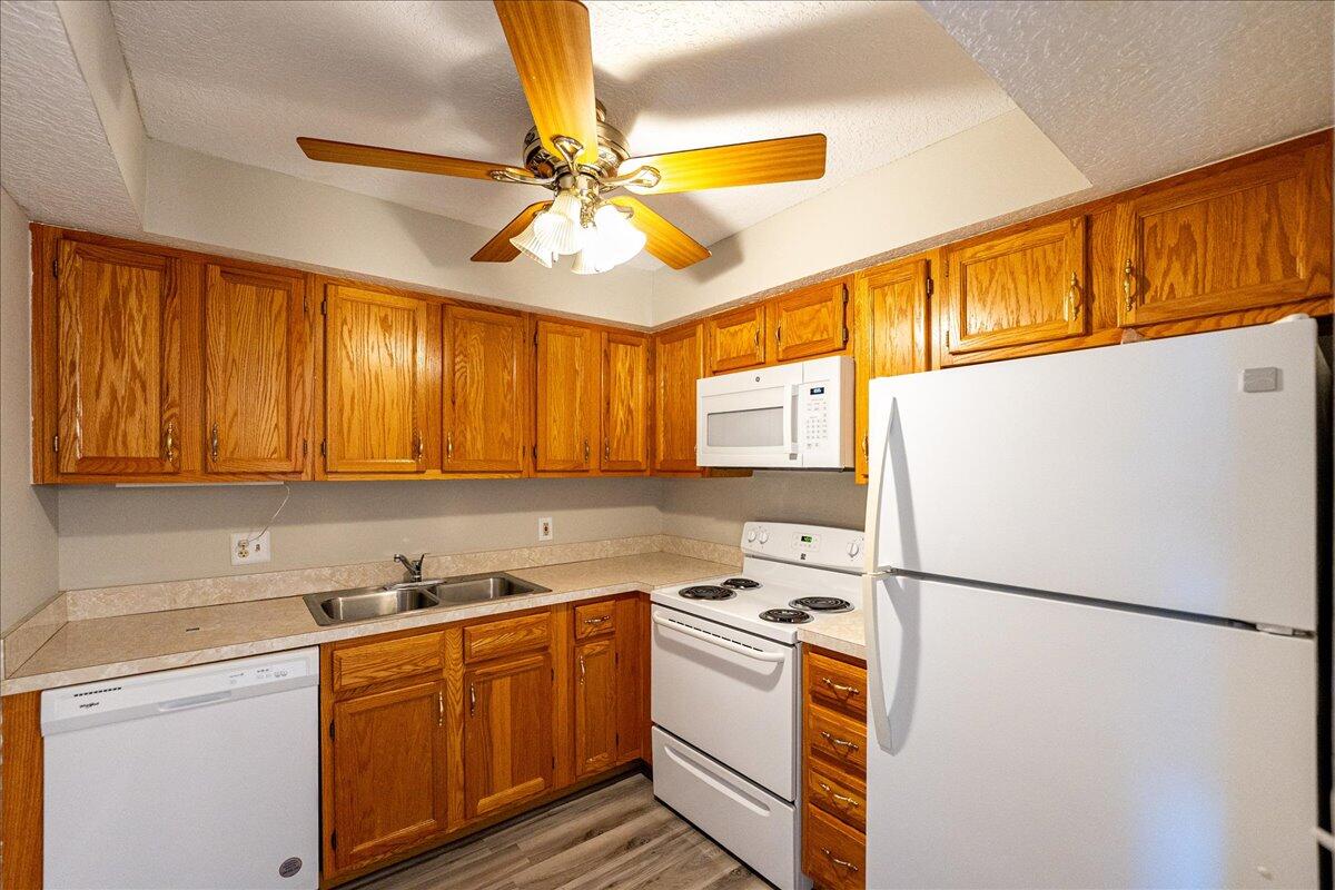 950 South Kanner Highway, Unit E4 Stuart, FL 34994 - Photo 3 of 33 a kitchen with stainless steel appliances granite countertop a refrigerator a stove a sink and a microwave