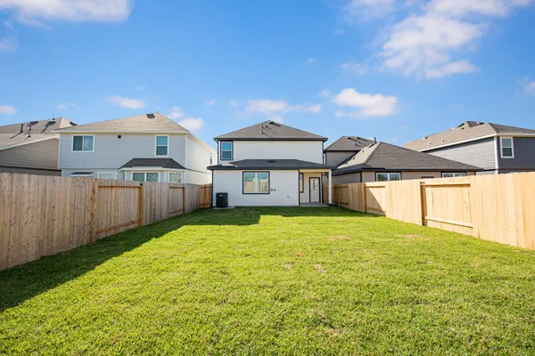 a view of a house with a yard and garage