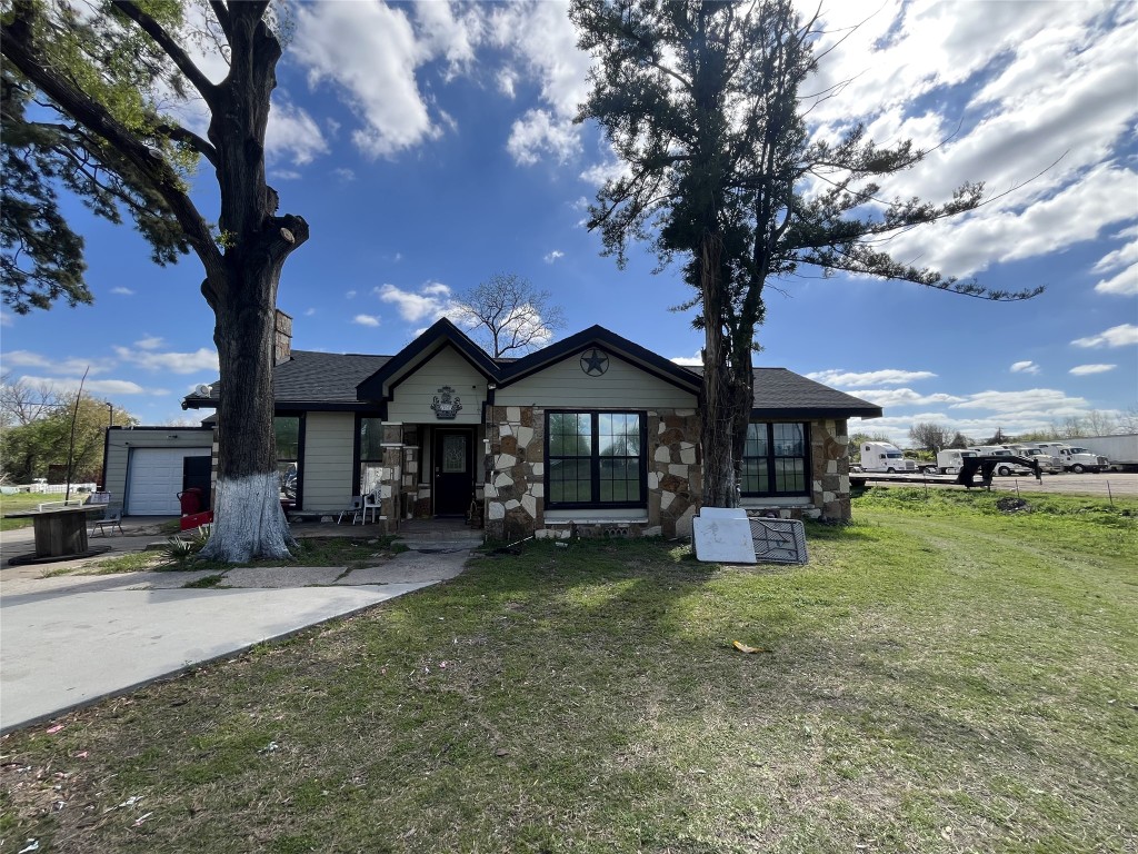 a house view with a sitting space and garden