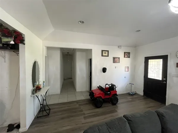 a view of a livingroom with furniture and a flat screen tv
