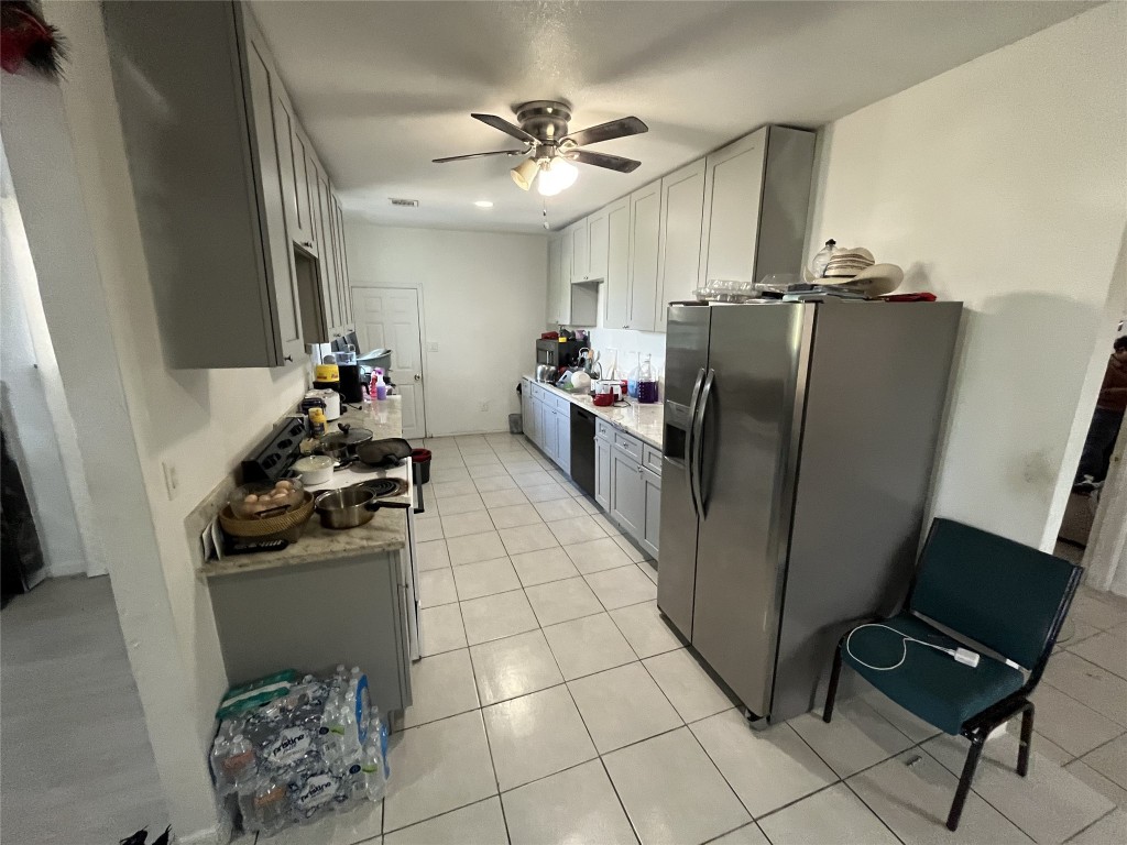 925 Lear Street Houston, TX 77015 - Photo 5 of 9 a kitchen with stainless steel appliances a refrigerator sink and microwave