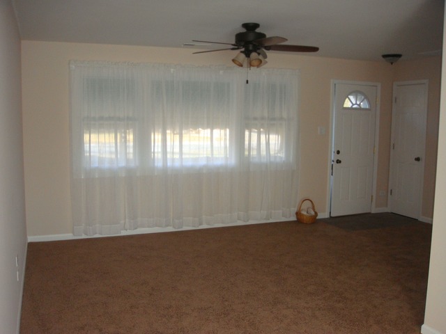 5718 South Peck Avenue Countryside, IL 60525 - Photo 3 of 12 an empty room with a empty space and windows
