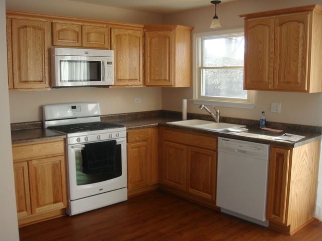 5718 South Peck Avenue Countryside, IL 60525 - Photo 5 of 12 a kitchen with sink a microwave and cabinets