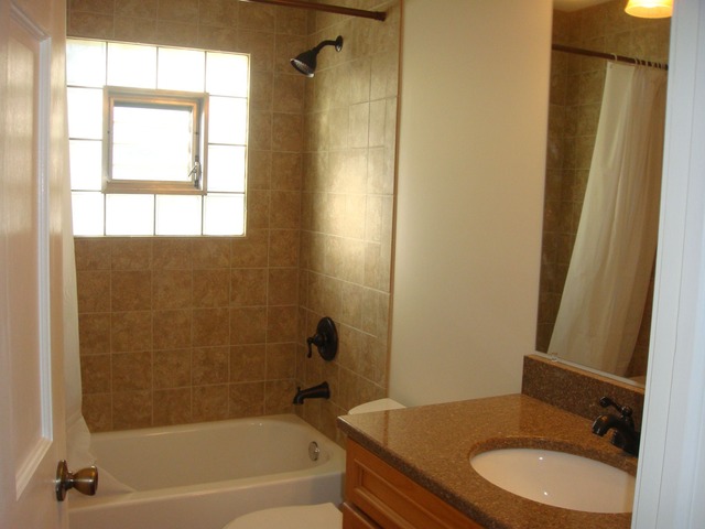5718 South Peck Avenue Countryside, IL 60525 - Photo 9 of 12 a bathroom with a granite countertop sink toilet and shower
