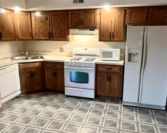 a kitchen with a stove a sink and a refrigerator