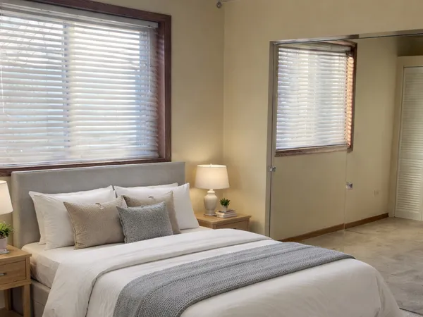 a bedroom with a bed and a window