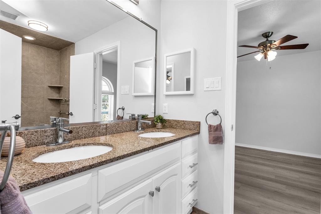 7233 Rustic Valley Drive Dallas, TX 75248 - Photo 16 of 21 a bathroom with a granite countertop sink and a mirror