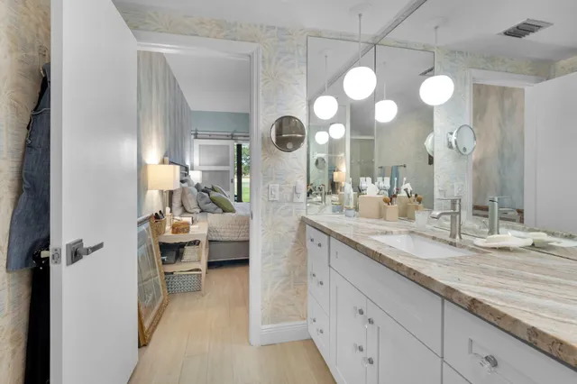 a bedroom with a bed and a painting on the wall