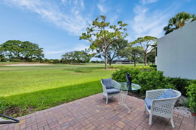 a front view of a house with a yard table and chairs