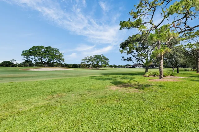 an aerial view of residential houses with outdoor space and swimming pool