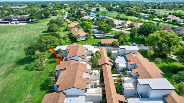 an aerial view of a house with a garden and lake view