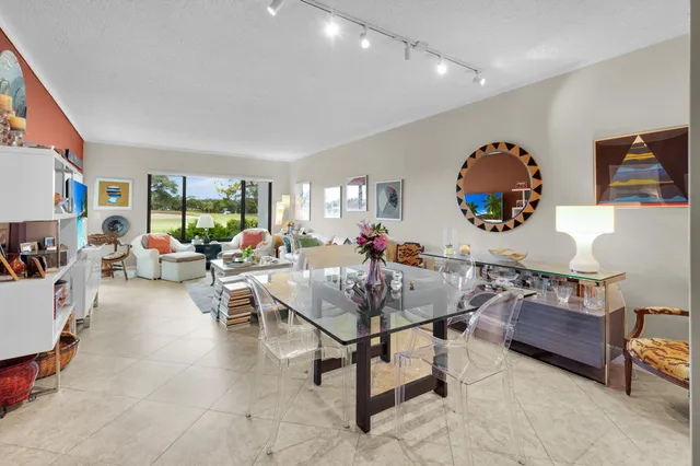 a living room with furniture a rug and a mirror
