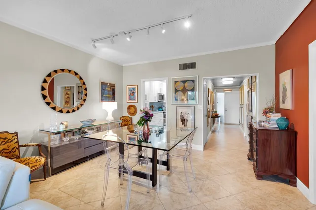 a living room with furniture and large windows