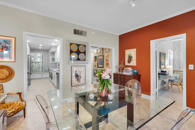 a kitchen with stainless steel appliances granite countertop a refrigerator a sink dishwasher a stove and white countertops with wooden floor