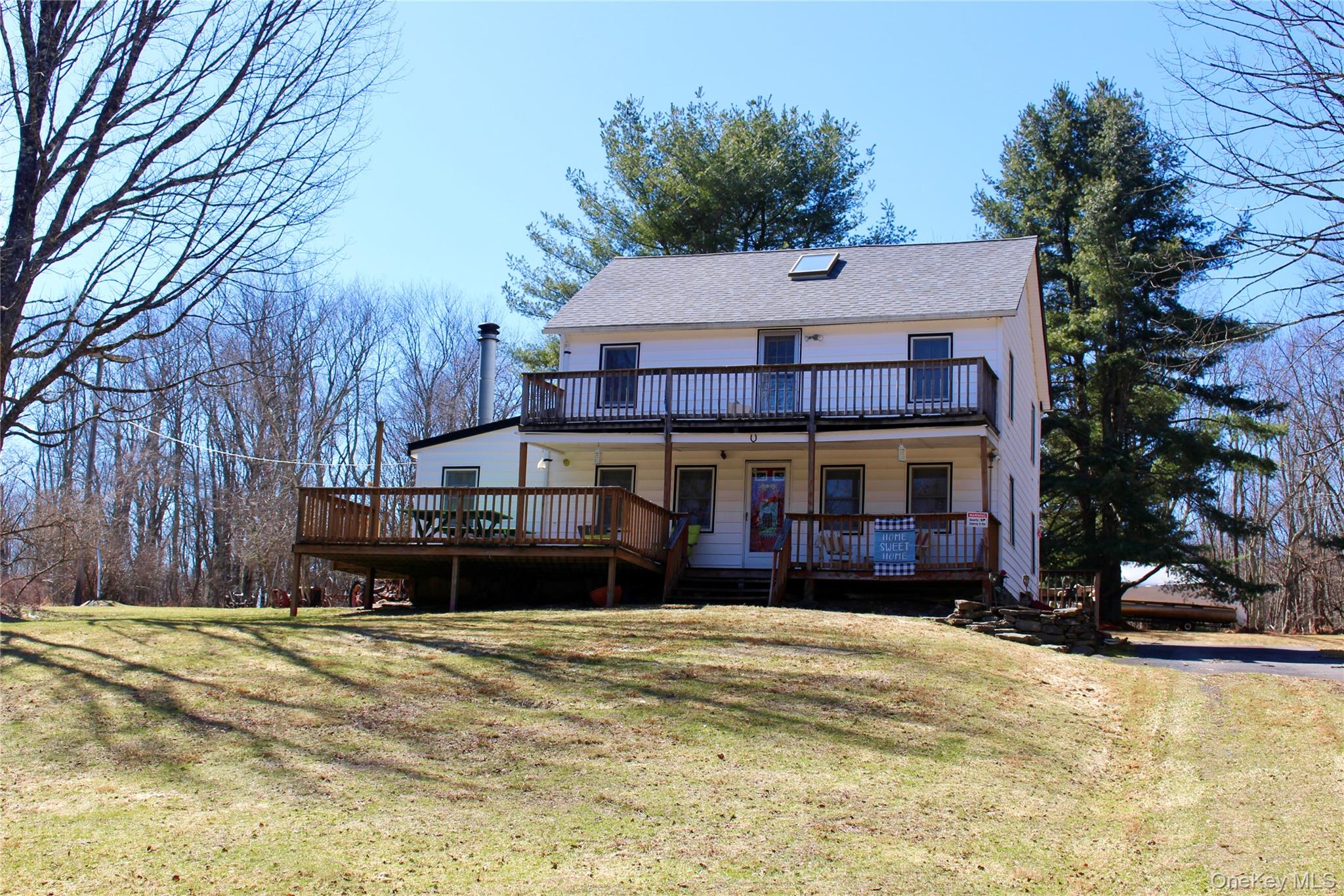 a view of a house with a yard covered in snow