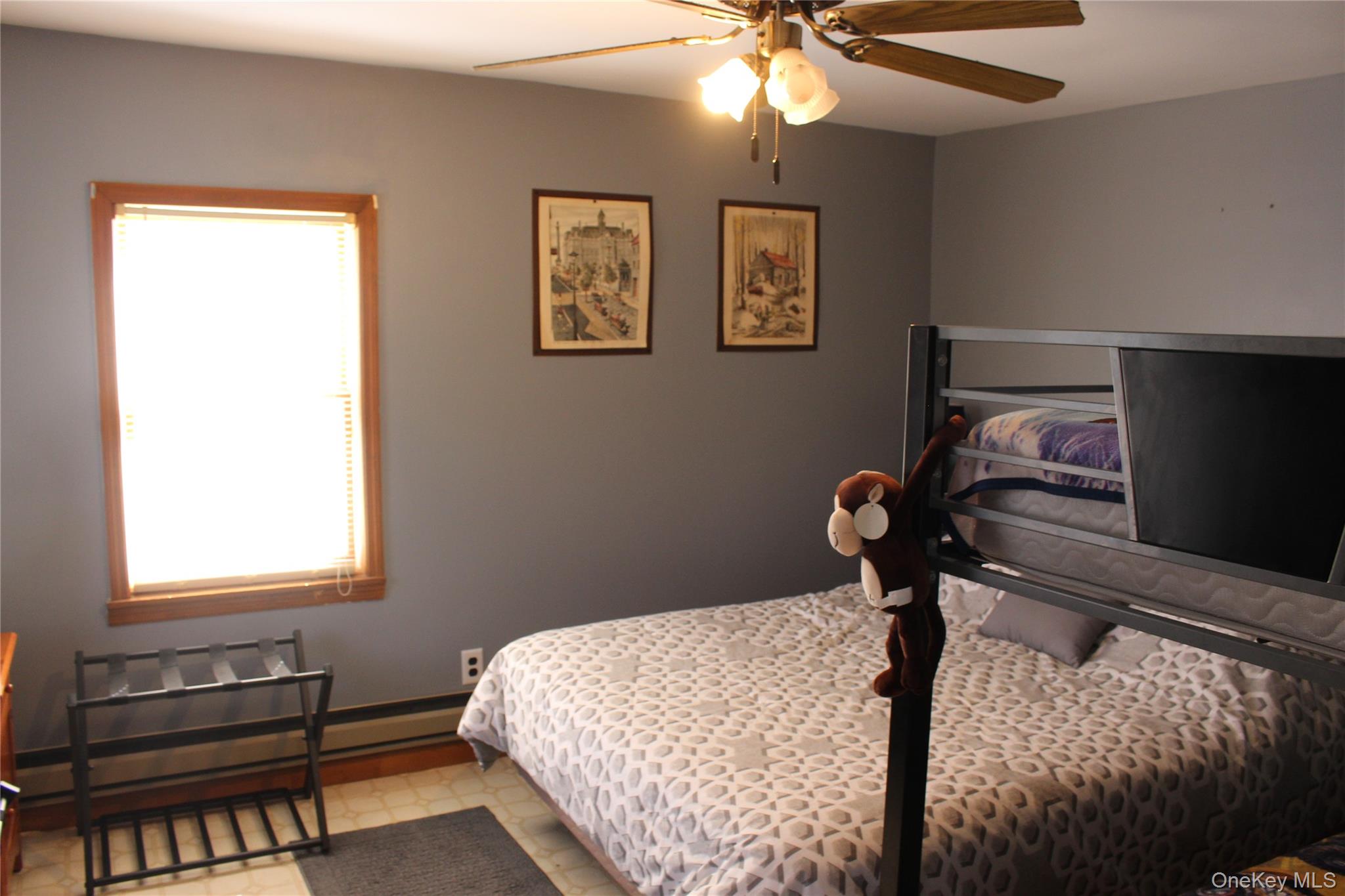 154 Britman Road Mongaup Valley, NY 12762 - Photo 17 of 38 a bedroom with a bed and a chandelier