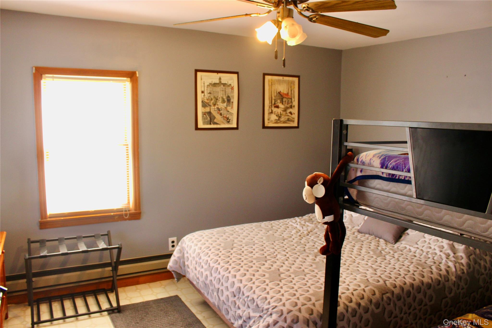 154 Britman Road Mongaup Valley, NY 12762 - Photo 35 of 38 a bedroom with a bed and a chandelier