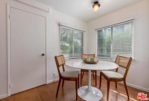 a view of a dining room with furniture and window