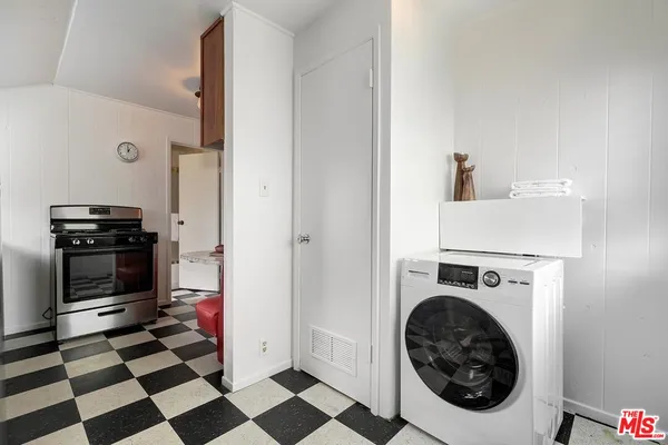a view of a storage and utility room with washer and dryer