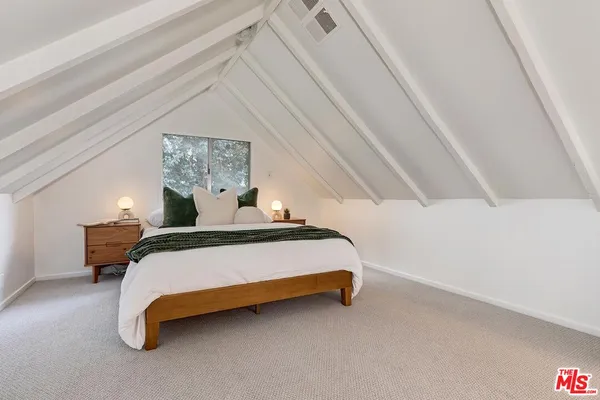 a bedroom with a bed and lamp