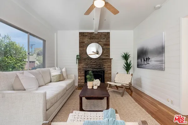a living room with furniture and a fireplace